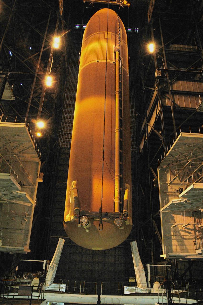 KENNEDY SPACE CENTER, FLA. - In high bay 3 of the Vehicle Assembly Building, the external tank designated for Space Shuttle Discovery is lowered into position between the solid rocket boosters on the mobile launcher platform. Discovery is scheduled to launch on mission STS-121 in July. Photo credit: NASA/Amanda Diller