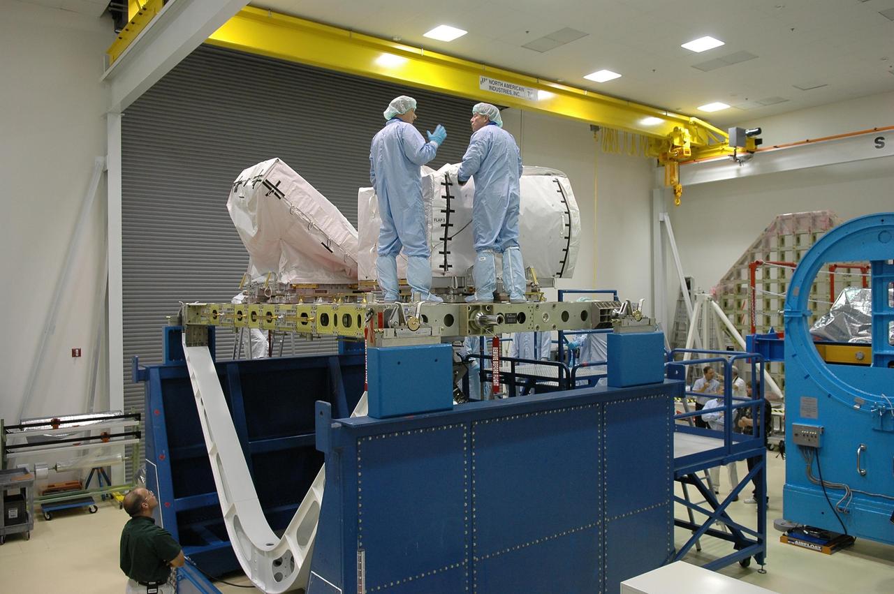 KENNEDY SPACE CENTER, FLA.  -  Mission Specialist Piers Sellers (left)  and Commander Steven Lindsey (right) are working with the pump module at the SPACEHAB facility in Cape Canaveral during a Crew Equipment Interface Test. This test allows the astronauts to become familiar with equipment they will be using on their upcoming mission. STS-121 is scheduled to launch in July aboard Space Shuttle Discovery.  Photo credit: NASA/Kim Shiflett