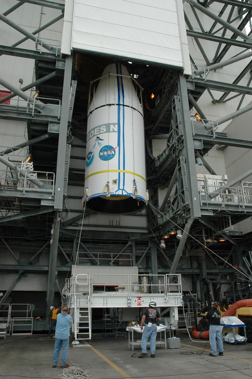 KENNEDY SPACE CENTER, FLA. - On Launch Complex 37 at Cape Canaveral Air Force Station in Florida, the GOES-N spacecraft is lifted into the mobile service tower. There it will be mated with the second stage of the Boeing Delta IV rocket. GOES-N is the latest in a series of Geostationary Operational Environmental Satellites for NOAA and NASA, providing continuous monitoring necessary for intensive data analysis. GOES-N is scheduled to be launched May 18 in an hour-long window between 6:14 and 7:14 p.m. EDT. Photo credit: NASA/Charisse Nahser