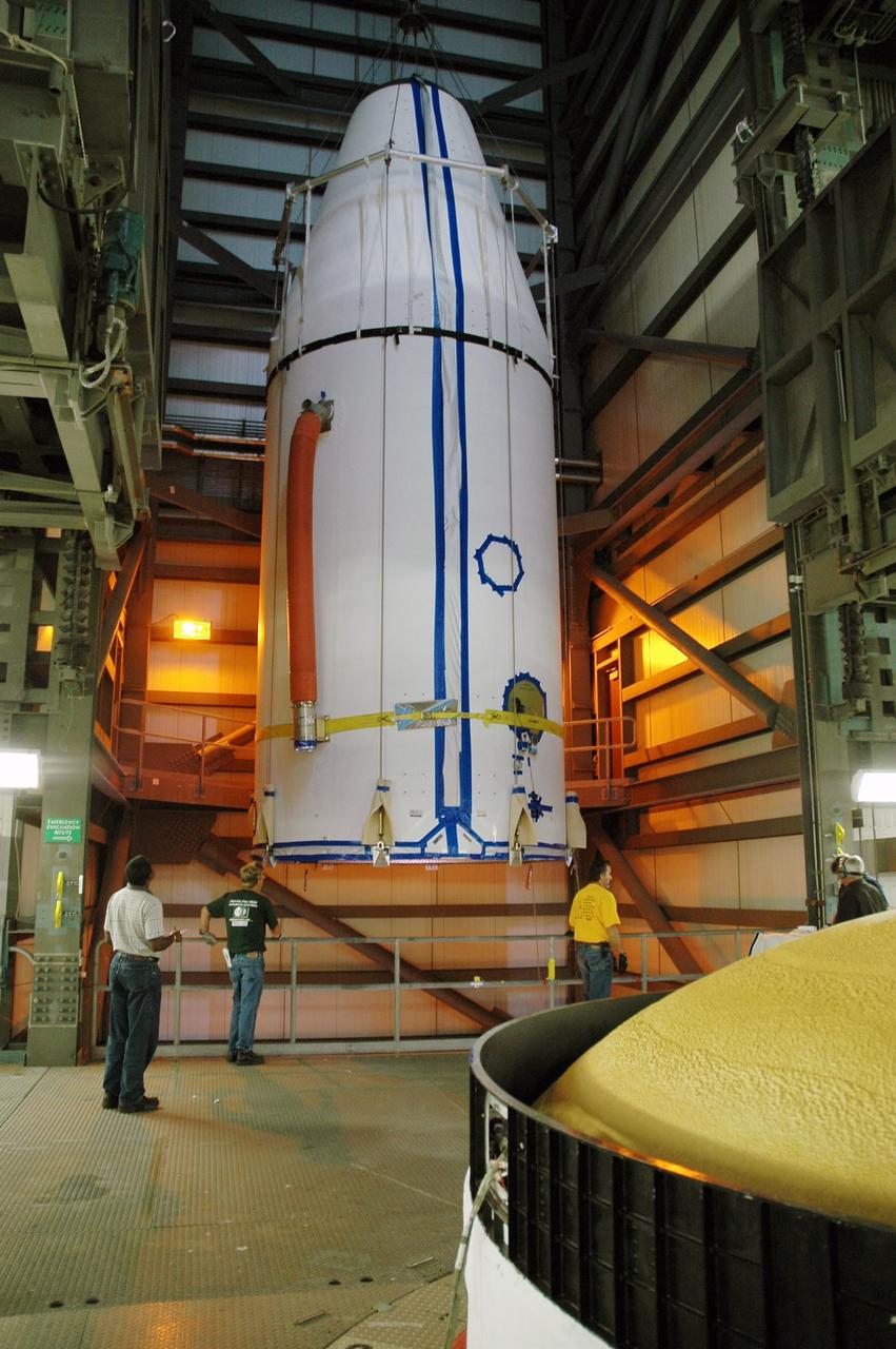 KENNEDY SPACE CENTER, FLA. - On Launch Complex 37 at Cape Canaveral Air Force Station in Florida, the GOES-N spacecraft arrives at the upper level of the mobile service tower and is moved toward the second stage of the Boeing Delta IV rocket (lower right). GOES-N is the latest in a series of Geostationary Operational Environmental Satellites for NOAA and NASA, providing continuous monitoring necessary for intensive data analysis. GOES-N is scheduled to be launched May 18 in an hour-long window between 6:14 and 7:14 p.m. EDT. Photo credit: NASA/Charisse Nahser