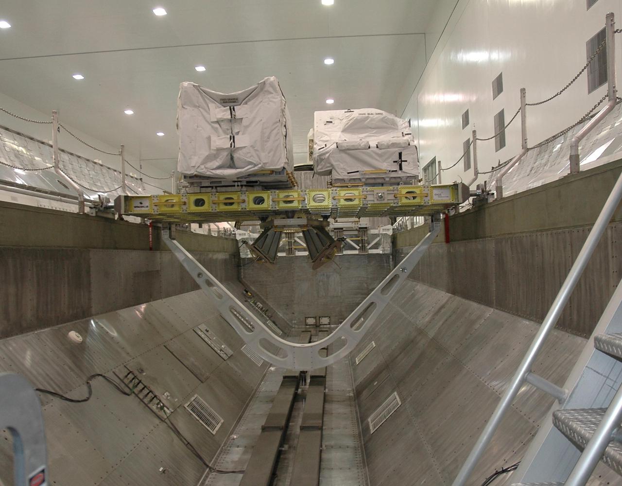 KENNEDY SPACE CENTER, FLA. - In NASA's Space Station Processing Facility, the Integrated Cargo Carrier (ICC) is seen inside the payload canister. The ICC is part of the payload on mission STS-121 to the International Space Station. The carrier holds the mobile transporter reel assembly that the astronauts will replace on the station and a spare pump module. The carrier and its cargo will be placed in Space Shuttle Discovery's payload bay at the pad. Discovery is scheduled to launch on mission STS-121 from Launch Pad 39B in a window that opens July 1 and extends to July 19. Photo credit: NASA/Cory Husten