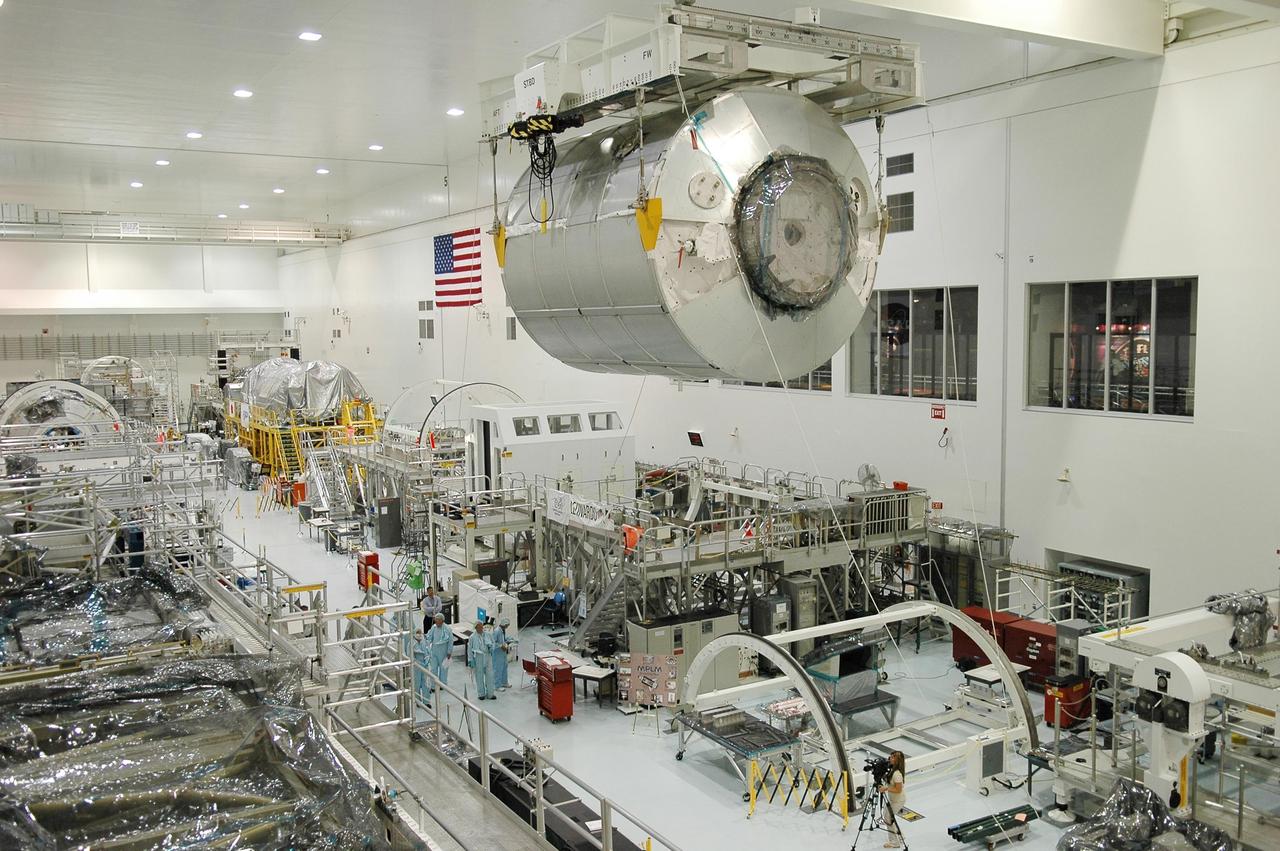 KENNEDY SPACE CENTER, FLA. - In the Space Station Processing Facility, the multi-purpose logistics module Leonardo is moved by crane across the building to the payload transportation canister for transfer to Launch Pad 39B. At the pad, the module will be installed in Space Shuttle Discovery's payload bay. Part of the payload for mission STS-121, Leonardo carries tons of supplies and experiments for the International Space Station and its crew. Discovery is scheduled to be launched in a window that extends from July 1 to July 19. Photo credit: NASA/Kim Shiflett