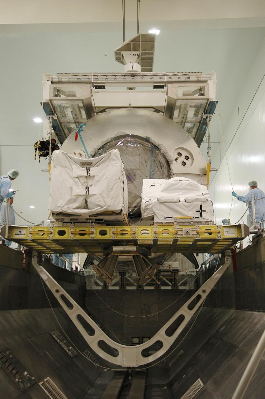 KENNEDY SPACE CENTER, FLA. - In the Space Station Processing Facility, the multi-purpose logistics module Leonardo is lowered next to the Integrated Cargo Carrier inside the payload transportation canister for transfer to Launch Pad 39B.  At the pad, the module  and carrier will be installed in Space Shuttle Discovery's payload bay.  Part of the payload for mission STS-121, Leonardo carries tons of supplies and experiments for the International Space Station and its crew.  Discovery is scheduled to be launched in a window that extends from July 1 to July 19.   Photo credit: NASA/Kim Shiflett