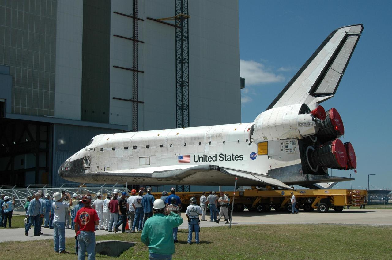 KENNEDY SPACE CENTER, FLA. - The orbiter Discovery, on top of an orbiter transporter, heads toward NASA's Vehicle Assembly Building (VAB) after leaving the Orbiter Processing Facility. The rollover to the VAB marks the start of the journey to the launch pad and, ultimately, launch. Once inside the VAB, Discovery will be raised to vertical and lifted up and over into high bay 3 for stacking with its redesigned external tank and twin solid rocket boosters. The rollout of Space Shuttle Discovery to Launch Pad 39B is expected in approximately a week. Launch of Discovery on mission STS-121 is scheduled to take place in a window extending July 1 to July 19. Photo credit: NASA/Jim Grossmann