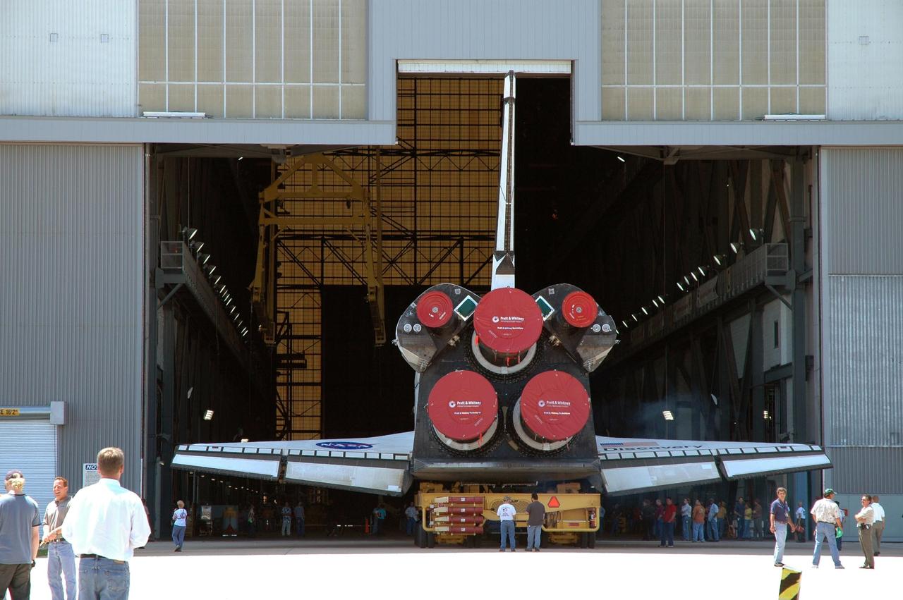 KENNEDY SPACE CENTER, FLA. - The orbiter Discovery, on top of an orbiter transporter, rolls into NASA's Vehicle Assembly Building (VAB) after leaving the Orbiter Processing Facility. The rollover to the VAB marks the start of the journey to the launch pad and, ultimately, launch. Once inside the VAB, Discovery will be raised to vertical and lifted up and over into high bay 3 for stacking with its redesigned external tank and twin solid rocket boosters. The rollout of Space Shuttle Discovery to Launch Pad 39B is expected in approximately a week. Launch of Discovery on mission STS-121 is scheduled to take place in a window extending July 1 to July 19. Photo credit: NASA/Jim Grossmann