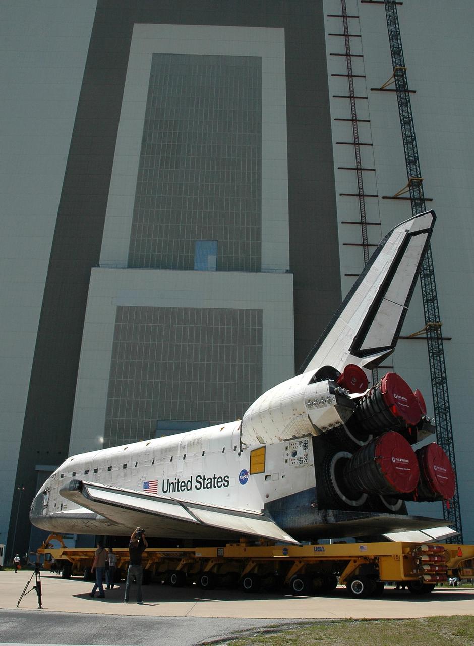 KENNEDY SPACE CENTER, FLA. - The orbiter Discovery, atop an orbiter transporter, turns toward NASA's Vehicle Assembly Building (VAB). The rollover marks the start of the journey to the launch pad and, ultimately, launch. Once inside the VAB, Discovery will be raised to vertical and lifted up and over into high bay 3 for stacking with its redesigned external tank and twin solid rocket boosters. The rollout of Space Shuttle Discovery to Launch Pad 39B is expected in approximately a week. Launch of Discovery on mission STS-121 is scheduled to take place in a window extending July 1 to July 19. Photo credit: NASA/Jack Pfaller