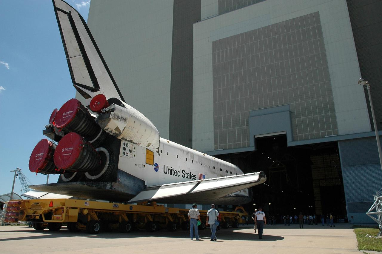 KENNEDY SPACE CENTER, FLA. - The orbiter Discovery, atop an orbiter transporter, nears the open panel on NASA's Vehicle Assembly Building (VAB). The rollover marks the start of the journey to the launch pad and, ultimately, launch. Once inside the VAB, Discovery will be raised to vertical and lifted up and over into high bay 3 for stacking with its redesigned external tank and twin solid rocket boosters. The rollout of Space Shuttle Discovery to Launch Pad 39B is expected in approximately a week. Launch of Discovery on mission STS-121 is scheduled to take place in a window extending July 1 to July 19. Photo credit: NASA/Jack Pfaller
