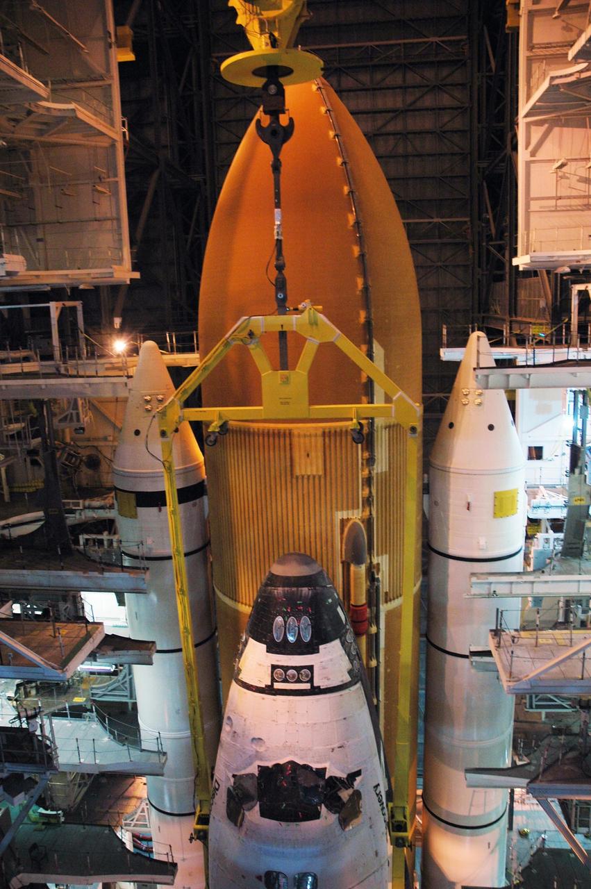 KENNEDY SPACE CENTER, FLA. --  The orbiter Discovery is lowered via a crane and sling into high bay 3 of NASA's Vehicle Assembly Building.  Discovery will be mated with its external tank and twin solid rocket boosters waiting below on the mobile launcher platform.  Space Shuttle Discovery is expected to roll out to Launch Pad 39B later this week via the crawler-transporter.  Launch of Discovery on mission STS-121 is scheduled to take place in a window extending July 1 to July 19.  Photo credit: NASA/Charisse Nahser