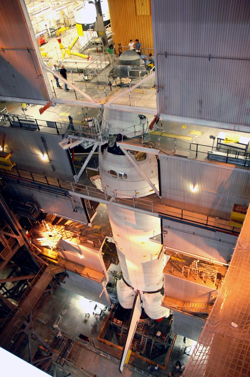 KENNEDY SPACE CENTER, FLA. --  High in NASA's Vehicle Assembly Building, Space Shuttle Discovery is in place on the mobile launcher platform.  The orbiter is being mated with its solid rocket boosters and external tank, which can be seen behind and above the orbiter. Space Shuttle Discovery is expected to roll out to Launch Pad 39B later this week via the crawler-transporter.  Launch of Discovery on mission STS-121 is scheduled to take place in a window extending July 1 to July 19. Photo credit: NASA/Jim Grossmann