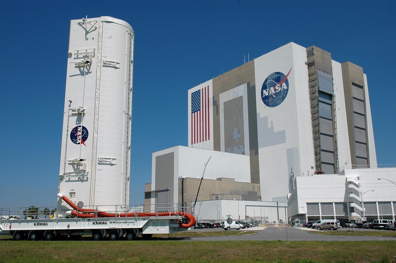 KENNEDY SPACE CENTER, FLA. --   The payload canister moves past NASA's Vehicle Assembly Building on its way to Launch Pad 39B.  Inside are the payloads for mission STS-121: the multi-purpose logistics module Leonardo, with supplies and equipment for the International Space Station; the lightweight multi-purpose experiment support structure carrier; and the integrated cargo carrier, with the mobile transporter reel assembly and a spare pump module.  The payload will be transferred from the canister to Space Shuttle Discovery's payload bay at the pad.  Discovery is scheduled to launch on mission STS-121 from Launch Pad 39B in a window that opens July 1 and extends to July 19.  Photo credit: NASA/Kim Shiflett