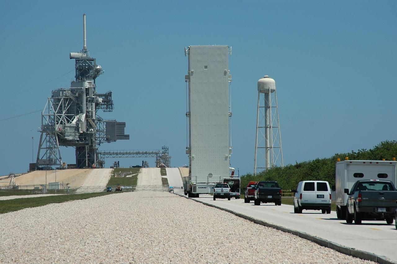 KENNEDY SPACE CENTER, FLA. -- The payload canister approaches the incline up to Launch Pad 39B at NASA's Kennedy Space Center. The canister holds the payloads for mission STS-121: the multi-purpose logistics module Leonardo, with supplies and equipment for the International Space Station; the lightweight multi-purpose experiment support structure carrier; and the integrated cargo carrier, with the mobile transporter reel assembly and a spare pump module. The payload will be transferred from the canister to Space Shuttle Discovery's payload bay at the pad. Discovery is scheduled to launch on mission STS-121 from Launch Pad 39B in a window that opens July 1 and extends to July 19. Photo credit: NASA/Kim Shiflett