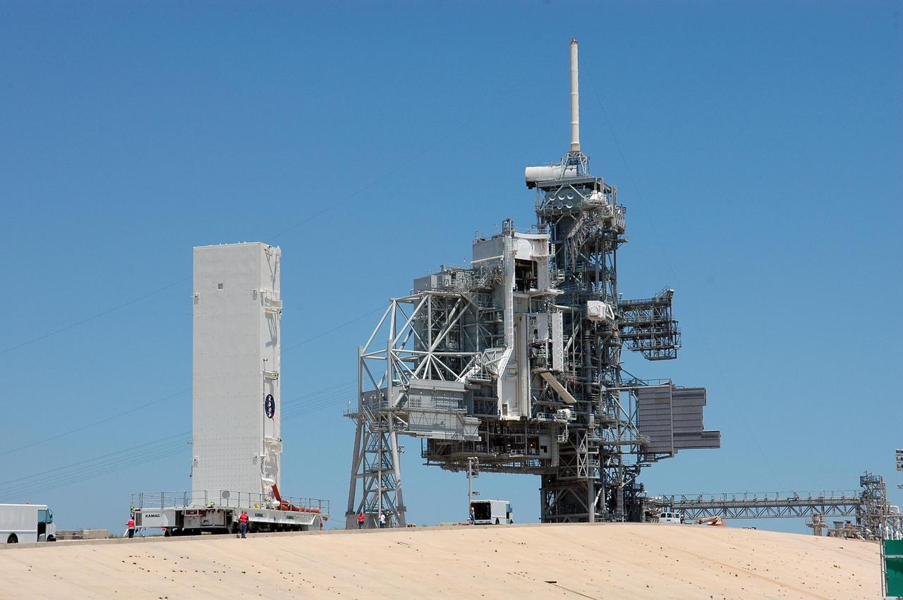KENNEDY SPACE CENTER, FLA. -- The payload canister approaches the rotating service structure on Launch Pad 39B at NASA's Kennedy Space Center. The canister holds the payloads for mission STS-121: the multi-purpose logistics module Leonardo, with supplies and equipment for the International Space Station; the lightweight multi-purpose experiment support structure carrier; and the integrated cargo carrier, with the mobile transporter reel assembly and a spare pump module. The payload will be transferred from the canister to Space Shuttle Discovery's payload bay at the pad. Discovery is scheduled to launch on mission STS-121 from Launch Pad 39B in a window that opens July 1 and extends to July 19. Photo credit: NASA/Kim Shiflett
