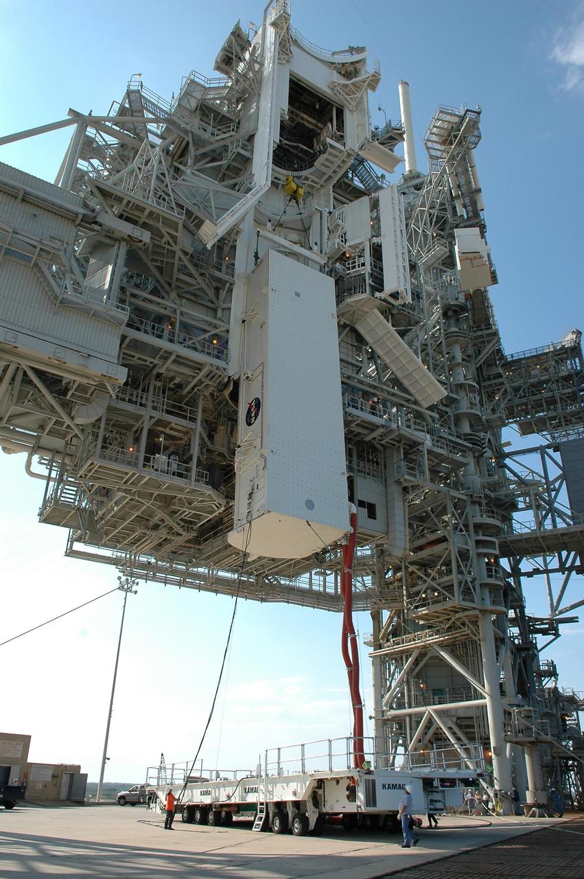KENNEDY SPACE CENTER, FLA. --   On Launch Pad 39B at NASA's Kennedy Space Center, the payload canister holding Space Shuttle Discovery's payloads nears the payload changeout room on the rotating service structure. The red umbilical lines are still attached. The payload changeout room provides an environmentally clean or "white room" condition in which to receive a payload transferred from a protective payload canister. After the shuttle arrives at the pad, the rotating service structure will close around it and the payloads, which include the multi-purpose logistics module and integrated cargo carrier, will then be transferred from the changeout room into Discovery's payload bay. Discovery's launch to the International Space Station on mission STS-121 is targeted for July 1 in a launch window that extends to July 19. During the 12-day mission, crew members will test new hardware and techniques to improve shuttle safety. Photo credit: NASA/Kim Shiflett