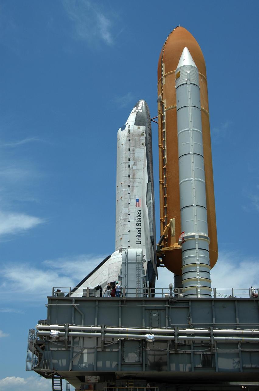 KENNEDY SPACE CENTER, FLA. -- Space Shuttle Discovery looms large in this closeup as it rolls to Launch Pad 39B. The shuttle rests on the mobile launcher platform. Underneath is the crawler, providing transport via the crawlerway. First motion of the shuttle from NASA's Vehicle Assembly Building was at 12:45 p.m. EDT. The rollout is an important step before launch of Discovery on mission STS-121 to the International Space Station. Discovery's launch is targeted for July 1 in a launch window that extends to July 19. During the 12-day mission, Discovery's crew will test new hardware and techniques to improve shuttle safety, as well as deliver supplies and make repairs to the station. Photo credit: NASA/Dimitri Gerondidakis
