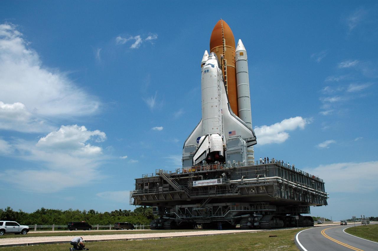 KENNEDY SPACE CENTER, FLA. -- Sitting on the mobile launcher platform, Space Shuttle Discovery rolls toward Launch Pad 39B via the crawler transporter. First motion of the shuttle from NASA's Vehicle Assembly Building was at 12:45 p.m. EDT. The rollout is an important step before launch of Discovery on mission STS-121 to the International Space Station. Discovery's launch is targeted for July 1 in a launch window that extends to July 19. During the 12-day mission, Discovery's crew will test new hardware and techniques to improve shuttle safety, as well as deliver supplies and make repairs to the station. Photo credit: NASA/Dimitri Gerondidakis
