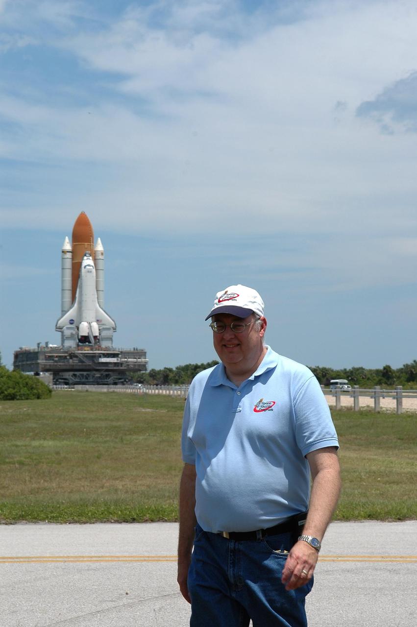 KENNEDY SPACE CENTER, FLA. --  Space Shuttle Program Director Wayne Hale is on hand to watch the historic moment of Space Shuttle Discovery's rollout to Launch Pad 39B. First motion of the shuttle (seen in the background)  from NASA's Vehicle Assembly Building was at 12:45 p.m. EDT.  The rollout is an important step before launch of Discovery on mission STS-121 to the International Space Station. Discovery's launch is targeted for July 1 in a launch window that extends to July 19. During the 12-day mission, Discovery's crew will test new hardware and techniques to improve shuttle safety, as well as deliver supplies and make repairs to the station.  Photo credit: NASA/Kim Shiflett