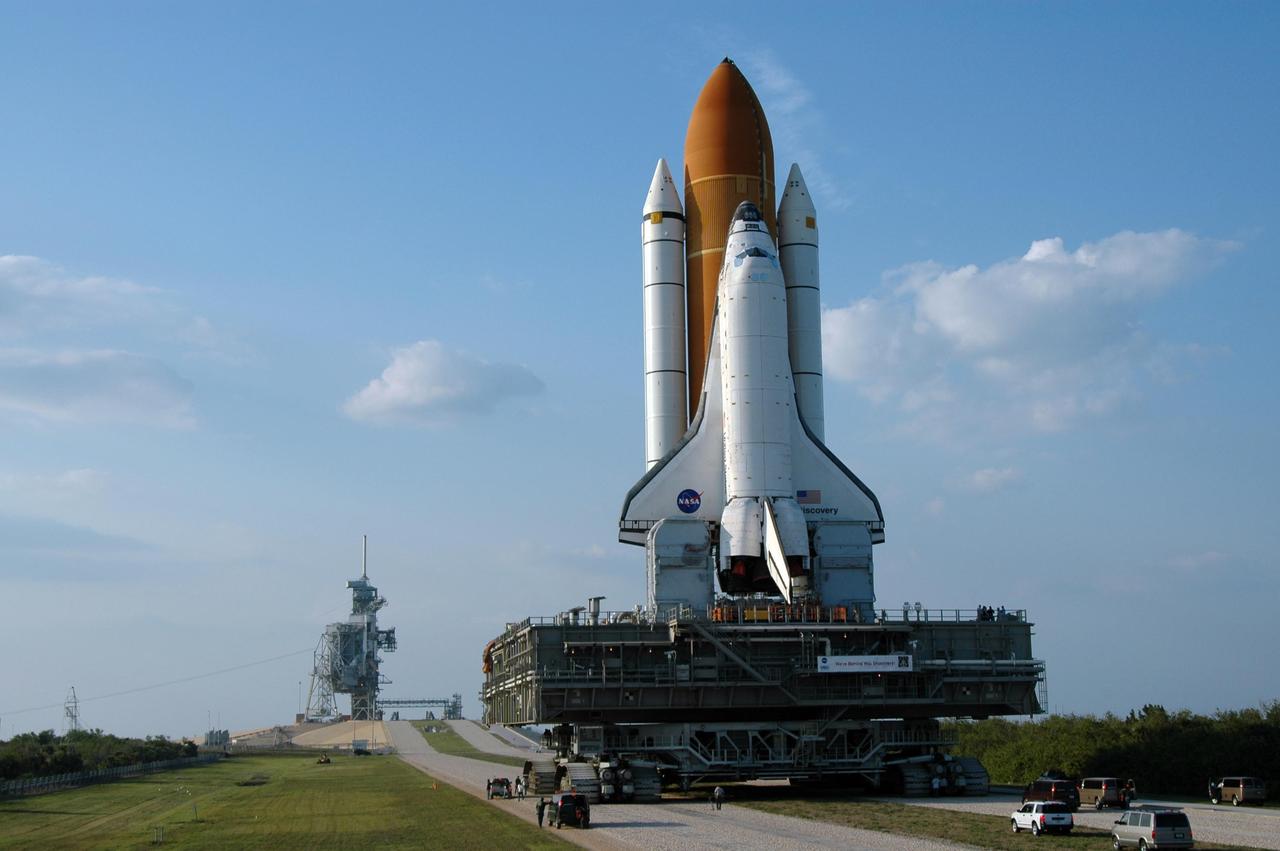 KENNEDY SPACE CENTER, FLA. --  Space Shuttle Discovery approaches the ramp on its rollout to Launch Pad 39B.  Discovery rests on top of the mobile launcher platform, which is carried by the crawler-transporter underneath.  First motion of the shuttle leaving NASA's Vehicle Assembly Building was at 12:45 p.m. EDT. The 4.2-mile journey from the VAB to the pad takes approximately 8 hours.  The rollout is an important step before launch of Discovery on mission STS-121 to the International Space Station.  Discovery's launch is targeted for July 1 in a launch window that extends to July 19. During the 12-day mission, Discovery's crew will test new hardware and techniques to improve shuttle safety, as well as deliver supplies and make repairs to the station.  Photo credit: NASA/Dimitri Gerondidakis