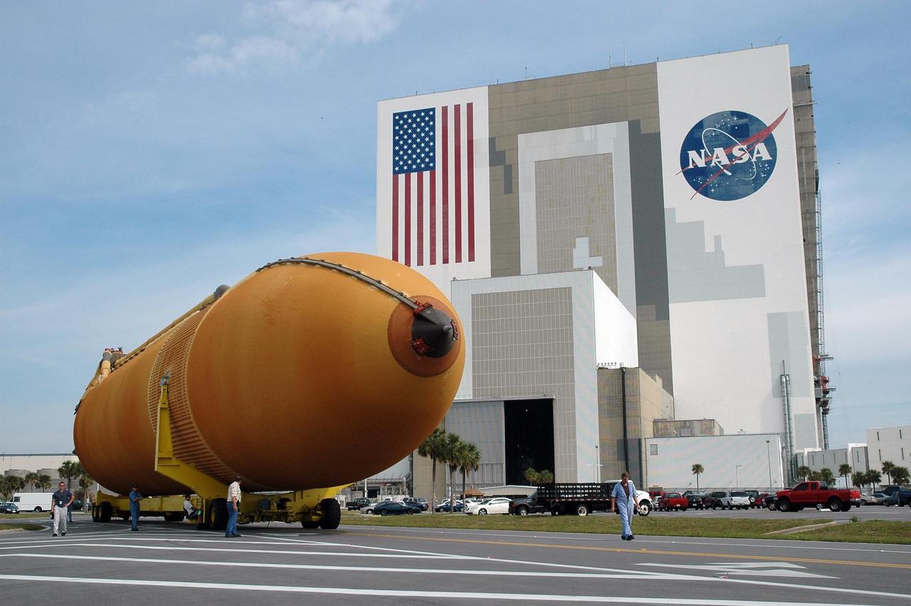 KENNEDY SPACE CENTER, FLA. --  External tank No. 117 makes the turn from the parking area at NASA's Vehicle Assembly Building.  It is heading for the barge waiting at the Turn Basin in the Launch Complex 39 Area. The tank is being shipped to NASA’s Michoud Assembly Facility in Louisiana for modifications.  The barge will be moved to Port Canaveral where one of NASA’s solid rocket booster retrieval ships will take it and tow it around the Florida peninsula to Michoud. Photo credit: NASA/Jack Pfaller