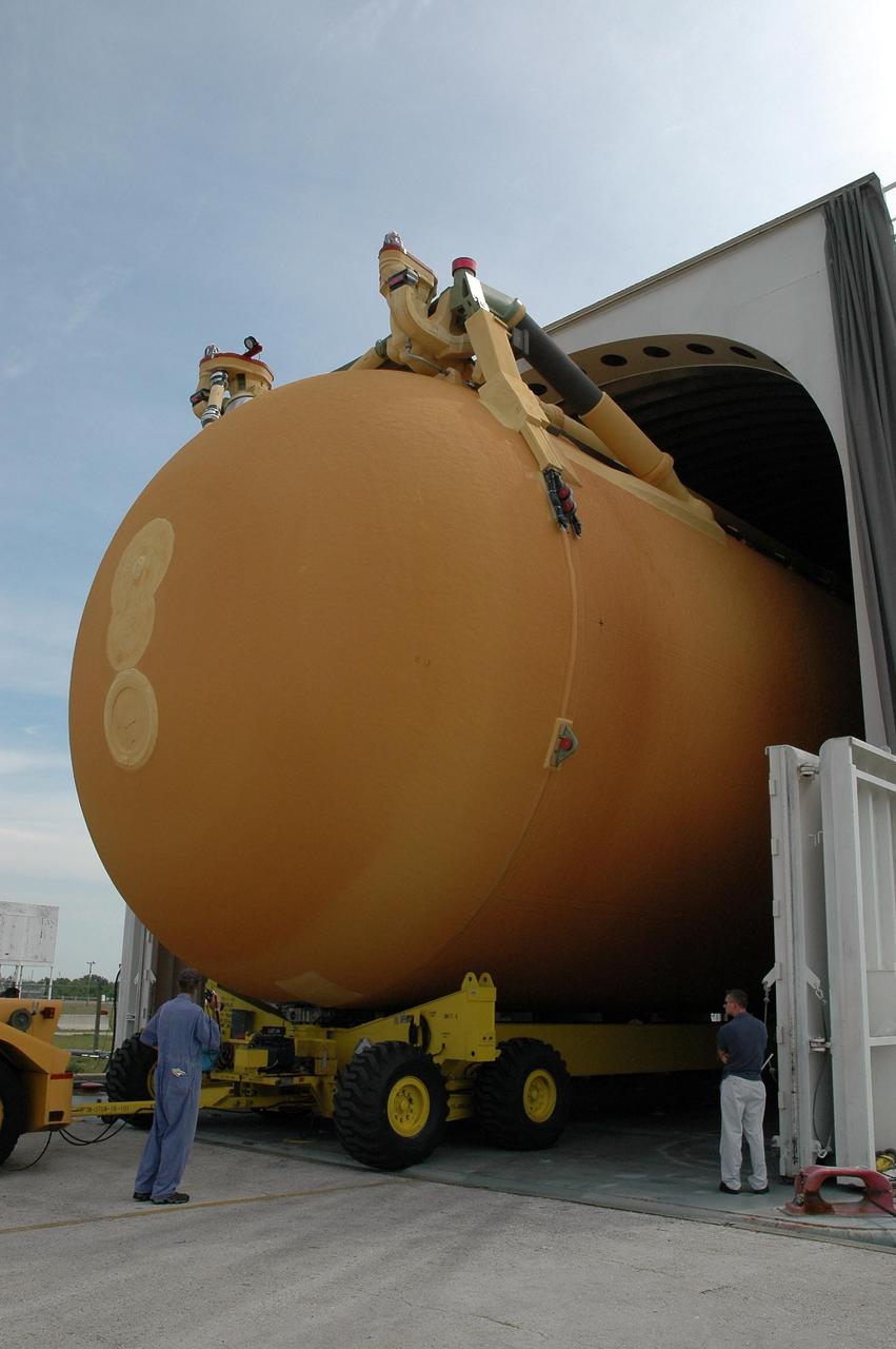 KENNEDY SPACE CENTER, FLA. -- External tank No. 117 rolls onto the barge at the Turn Basin in the Launch Complex 39 Area after being moved from NASA's Vehicle Assembly Building. The tank is being shipped to NASA’s Michoud Assembly Facility in Louisiana for modifications. The barge will be moved to Port Canaveral where one of NASA’s solid rocket booster retrieval ships will take it and tow it around the Florida peninsula to Michoud. Photo credit: NASA/Jack Pfaller