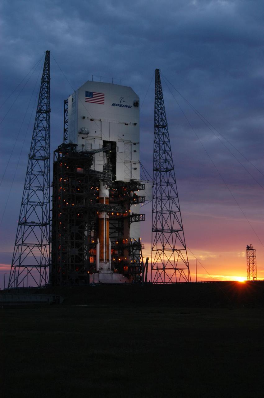 KENNEDY SPACE CENTER, FLA. - As the sun rises, a Boeing Delta IV rocket stands ready to launch the GOES-N satellite at Launch Complex 37 at Cape Canaveral Air Force Station. GOES-N is the latest in a series of Geostationary Operational Environmental Satellites for NOAA and NASA. A geostationary orbit is one in which a satellite remains in the same position with respect to the rotating Earth. Thus, the satellite hovers continuously over one position on the Earth's surface, appearing stationary. As a result, GOES provide a constant vigil for the atmospheric "triggers" for severe weather conditions such as tornadoes, flash floods, hail storms, and hurricanes. GOES-N is scheduled for launch May 24 in an hour-long window between 6:11 and 7:11 p.m. EDT. Photo credit: NASA/George Shelton