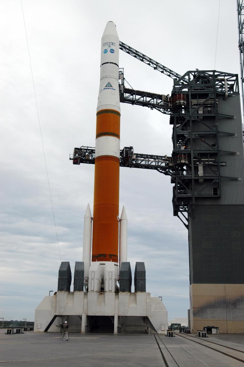 KENNEDY SPACE CENTER, FLA. - The mobile service tower on Launch Complex 37 at Cape Canaveral Air Force Station has been rolled back to reveal the Boeing Delta IV rocket that will launch the GOES-N satellite into orbit. GOES-N is the latest in a series of Geostationary Operational Environmental Satellites for NOAA and NASA. A geostationary orbit is one in which a satellite remains in the same position with respect to the rotating Earth. Thus, the satellite hovers continuously over one position on the Earth's surface, appearing stationary. As a result, GOES provide a constant vigil for the atmospheric "triggers" for severe weather conditions such as tornadoes, flash floods, hail storms, and hurricanes. GOES-N is scheduled for launch May 24 in an hour-long window between 6:11 and 7:11 p.m. EDT. Photo credit: NASA/George Shelton