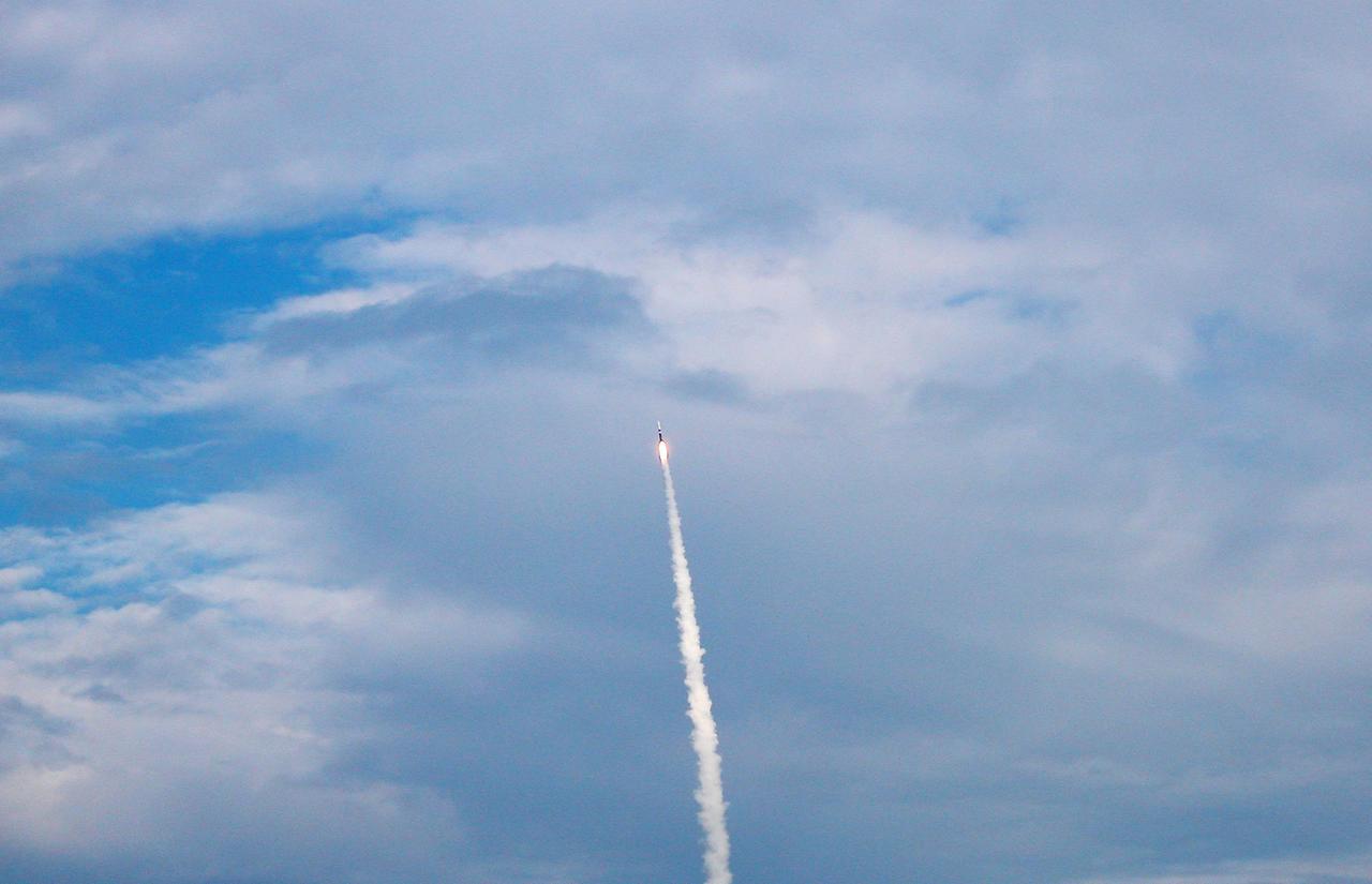 KENNEDY SPACE CENTER, FLA. - The GOES-N satellite roars through the thin cloud cover over the Space Coast atop a Boeing Delta IV rocket. Liftoff from Launch Complex 37 at Cape Canaveral Air Force Station was on time at 6:11 p.m. EDT. GOES-N is the latest in the Earth-monitoring series of Geostationary Operational Environmental Satellites developed by NASA and the National Oceanic and Atmospheric Administration. By maintaining a stationary orbit, hovering over one position on the Earth's surface, GOES will be able to provide a constant vigil for the atmospheric "triggers" for severe weather conditions such as tornadoes, flash floods, hail storms and hurricanes. Photo credit: NASA/Debbie Kiger