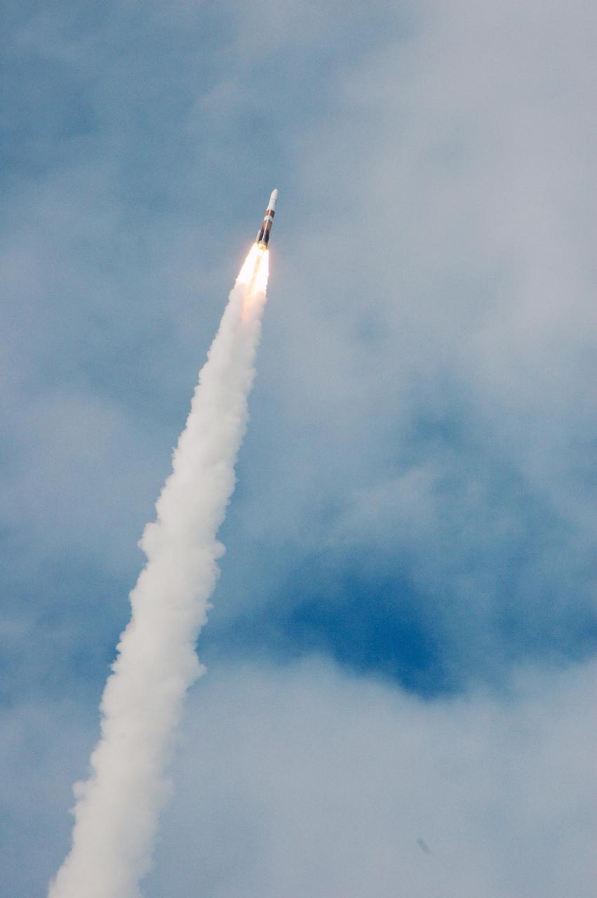 KENNEDY SPACE CENTER, FLA. - With flames close behind it, the Boeing Delta IV rocket roars through the thin cloud cover, lifting the GOES-N satellite in to space. Liftoff from Launch Complex 37 at Cape Canaveral Air Force Station was on time at 6:11 p.m. EDT. GOES-N is the latest in the Earth-monitoring series of Geostationary Operational Environmental Satellites developed by NASA and the National Oceanic and Atmospheric Administration. By maintaining a stationary orbit, hovering over one position on the Earth's surface, GOES will be able to provide a constant vigil for the atmospheric "triggers" for severe weather conditions such as tornadoes, flash floods, hail storms and hurricanes. Photo credit: NASA/Ken Thornsley
