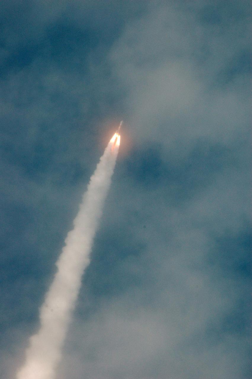 KENNEDY SPACE CENTER, FLA. - With flames close behind it, the Boeing Delta IV rocket trails a plume of smoke as it roars through the thin cloud cover, lifting the GOES-N satellite in to space. Liftoff from Launch Complex 37 at Cape Canaveral Air Force Station was on time at 6:11 p.m. EDT. GOES-N is the latest in the Earth-monitoring series of Geostationary Operational Environmental Satellites developed by NASA and the National Oceanic and Atmospheric Administration. By maintaining a stationary orbit, hovering over one position on the Earth's surface, GOES will be able to provide a constant vigil for the atmospheric "triggers" for severe weather conditions such as tornadoes, flash floods, hail storms and hurricanes. Photo credit: NASA/Ken Thornsley