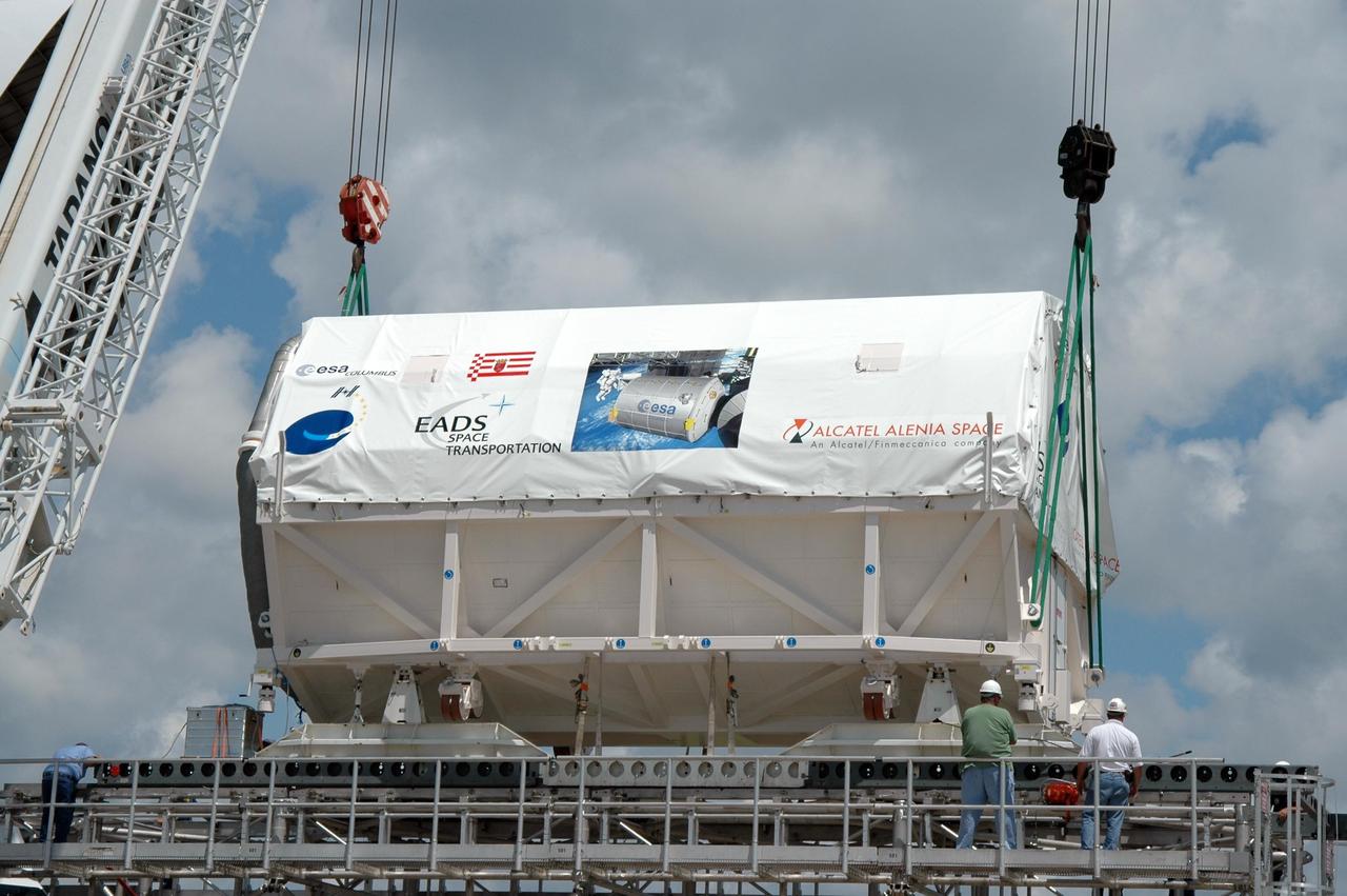 KENNEDY SPACE CENTER, FLA. -   At the Shuttle Landing Facility, a crane lifts Columbus, the European Space Agency's research laboratory, off an Airbus Transport International platform to place it onto a flat bed truck.  The module will be transported to the Space Station Processing Facility at NASA's Kennedy Space Center.  The module arrived on a Beluga Airbus May 30 at NASA's Kennedy Space Center from the manufacturer in Germany.  In the SSPF, the module will be prepared for delivery to the International Space Station on a future space shuttle mission.  Columbus will expand the research facilities of the station and provide researchers with the ability to conduct numerous experiments in the area of life, physical and materials sciences.  Photo credit: NASA/Jim Grossmann