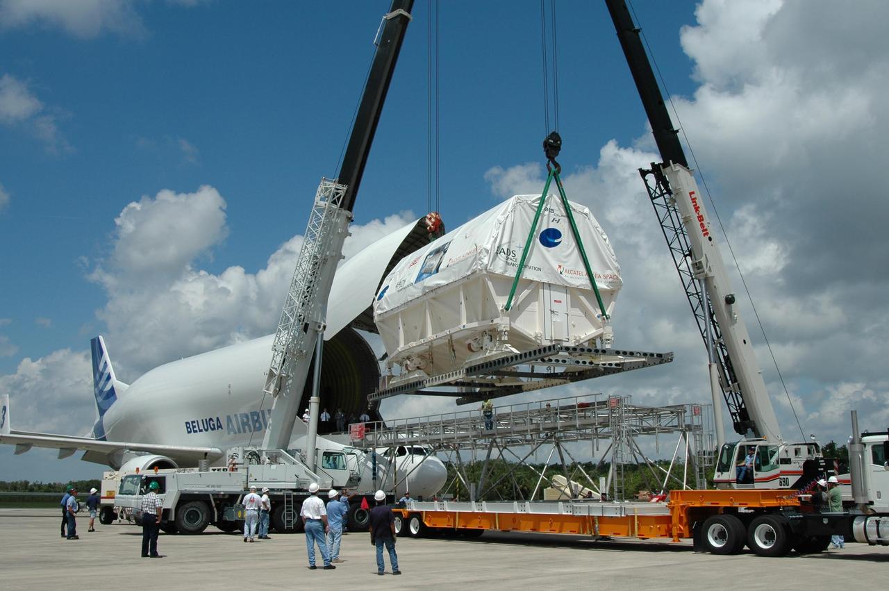KENNEDY SPACE CENTER, FLA. -   At the Shuttle Landing Facility, a crane lifts Columbus, the European Space Agency's research laboratory, off an Airbus Transport International platform toward a flat bed truck.  The truck will transport the module to the Space Station Processing Facility at NASA's Kennedy Space Center.   The module arrived on a Beluga Airbus May 30 at NASA's Kennedy Space Center from the manufacturer in Germany.  In the SSPF, the module will be prepared for delivery to the International Space Station on a future space shuttle mission.  Columbus will expand the research facilities of the station and provide researchers with the ability to conduct numerous experiments in the area of life, physical and materials sciences.  Photo credit: NASA/Jim Grossmann