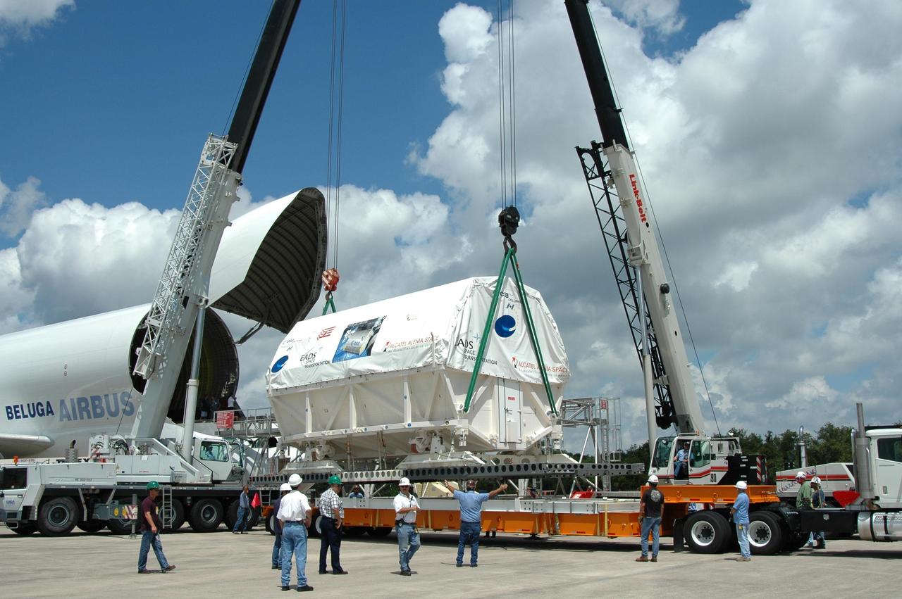 KENNEDY SPACE CENTER, FLA. -   At the Shuttle Landing Facility, a crane lowers Columbus, the European Space Agency's research laboratory, toward a flat bed truck.  The truck will transport the module to the Space Station Processing Facility at NASA's Kennedy Space Center.  The module arrived on a Beluga Airbus May 30 at NASA's Kennedy Space Center from the manufacturer in Germany.  In the SSPF, the module will be prepared for delivery to the International Space Station on a future space shuttle mission.  Columbus will expand the research facilities of the station and provide researchers with the ability to conduct numerous experiments in the area of life, physical and materials sciences.  Photo credit: NASA/Jim Grossmann