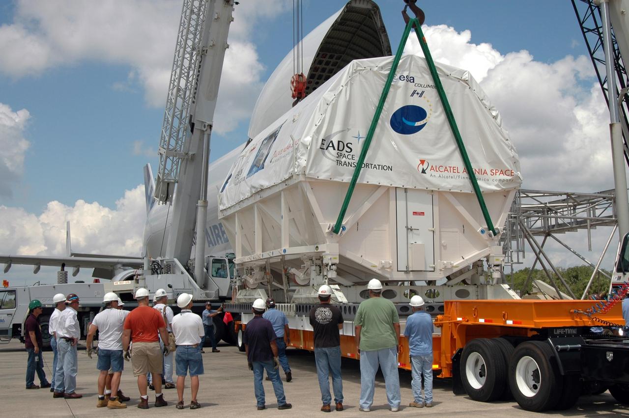 KENNEDY SPACE CENTER, FLA. -   At the Shuttle Landing Facility, a crane settles Columbus, the European Space Agency's research laboratory, onto a flat bed truck.  The truck will transport the module to the Space Station Processing Facility at NASA's Kennedy Space Center.   The module arrived on a Beluga Airbus May 30 at NASA's Kennedy Space Center from the manufacturer in Germany.  In the SSPF, the module will be prepared for delivery to the International Space Station on a future space shuttle mission.  Columbus will expand the research facilities of the station and provide researchers with the ability to conduct numerous experiments in the area of life, physical and materials sciences.  Photo credit: NASA/Jim Grossmann