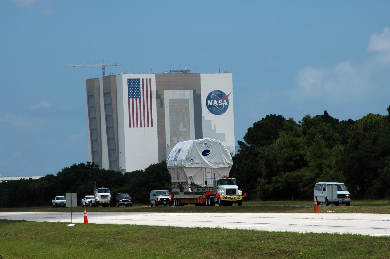 KENNEDY SPACE CENTER, FLA. -   Columbus, the European Space Agency's research laboratory, is moved under escort past the Vehicle Assembly Building.  It is heading to the Space Station Processing Facility at NASA's Kennedy Space Center.   The module arrived on a Beluga Airbus May 30 at NASA's Kennedy Space Center from the manufacturer in Germany.  In the SSPF, the module will be prepared for delivery to the International Space Station on a future space shuttle mission.  Columbus will expand the research facilities of the station and provide researchers with the ability to conduct numerous experiments in the area of life, physical and materials sciences.  Photo credit: NASA/Jim Grossmann