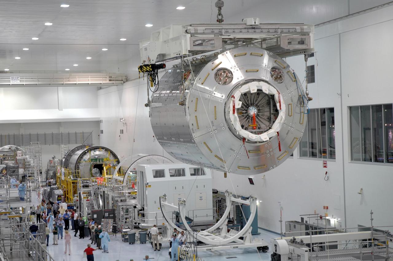 KENNEDY SPACE CENTER, FLA. -  Inside the Space Station Processing Facility at NASA's Kennedy Space Center, an overhead crane carries the Columbus module away from its transportation canister.  Columbus is the European Space Agency's research laboratory for the International Space Station. The module is being moved to a work stand to prepare it for delivery to the space station on a future space shuttle mission.  Columbus will expand the research facilities of the station and provide researchers with the ability to conduct numerous experiments in the area of life, physical and materials sciences.  Photo credit: NASA/Jim Grossmann