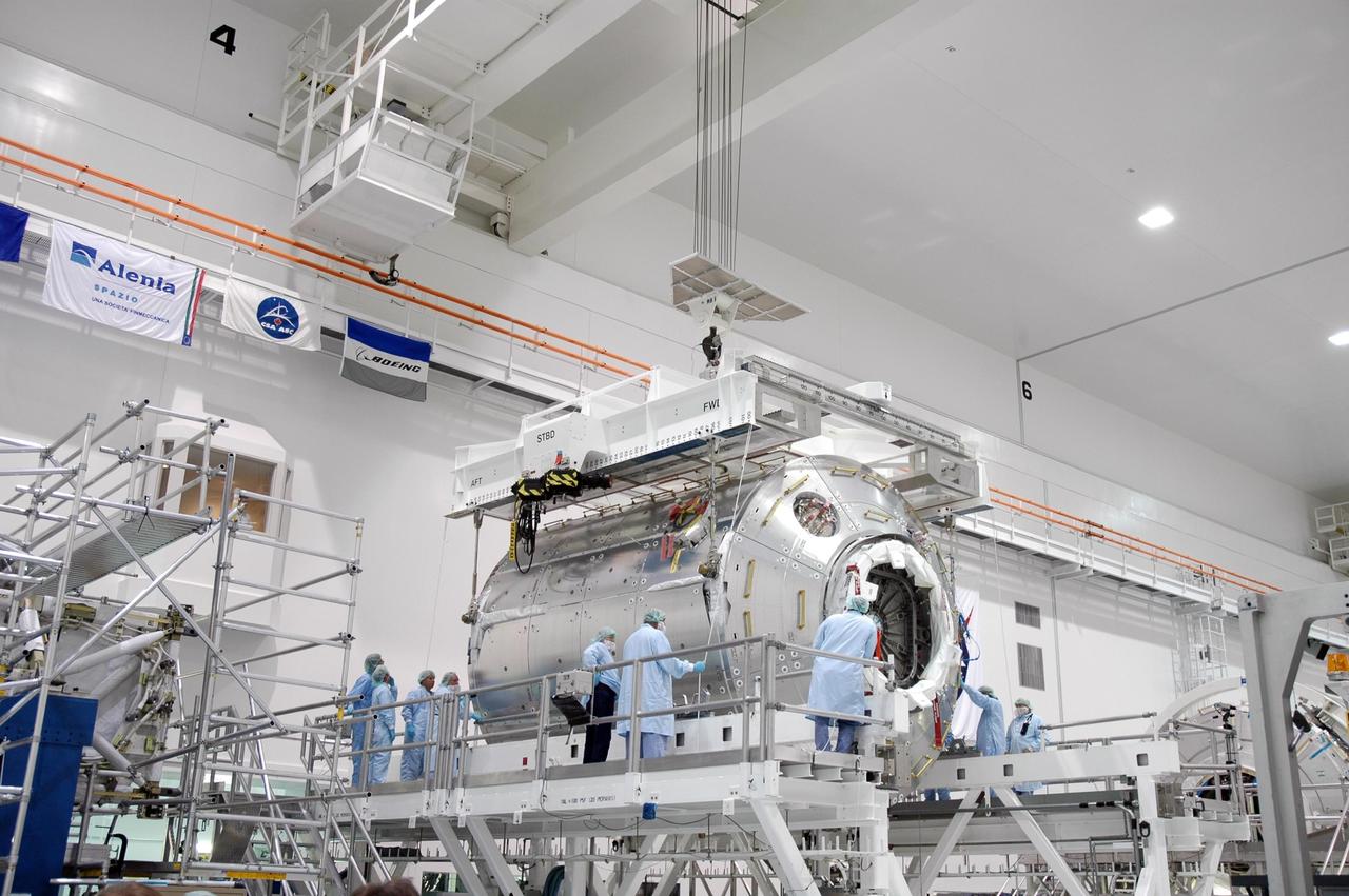 KENNEDY SPACE CENTER, FLA. -  Inside the Space Station Processing Facility at NASA's Kennedy Space Center, an overhead crane settles the Columbus module onto a work stand.  Columbus is the European Space Agency's research laboratory for the International Space Station.  The module will be prepared for delivery to the space station on a future space shuttle mission.  Columbus will expand the research facilities of the station and provide researchers with the ability to conduct numerous experiments in the area of life, physical and materials sciences.  Photo credit: NASA/Jim Grossmann