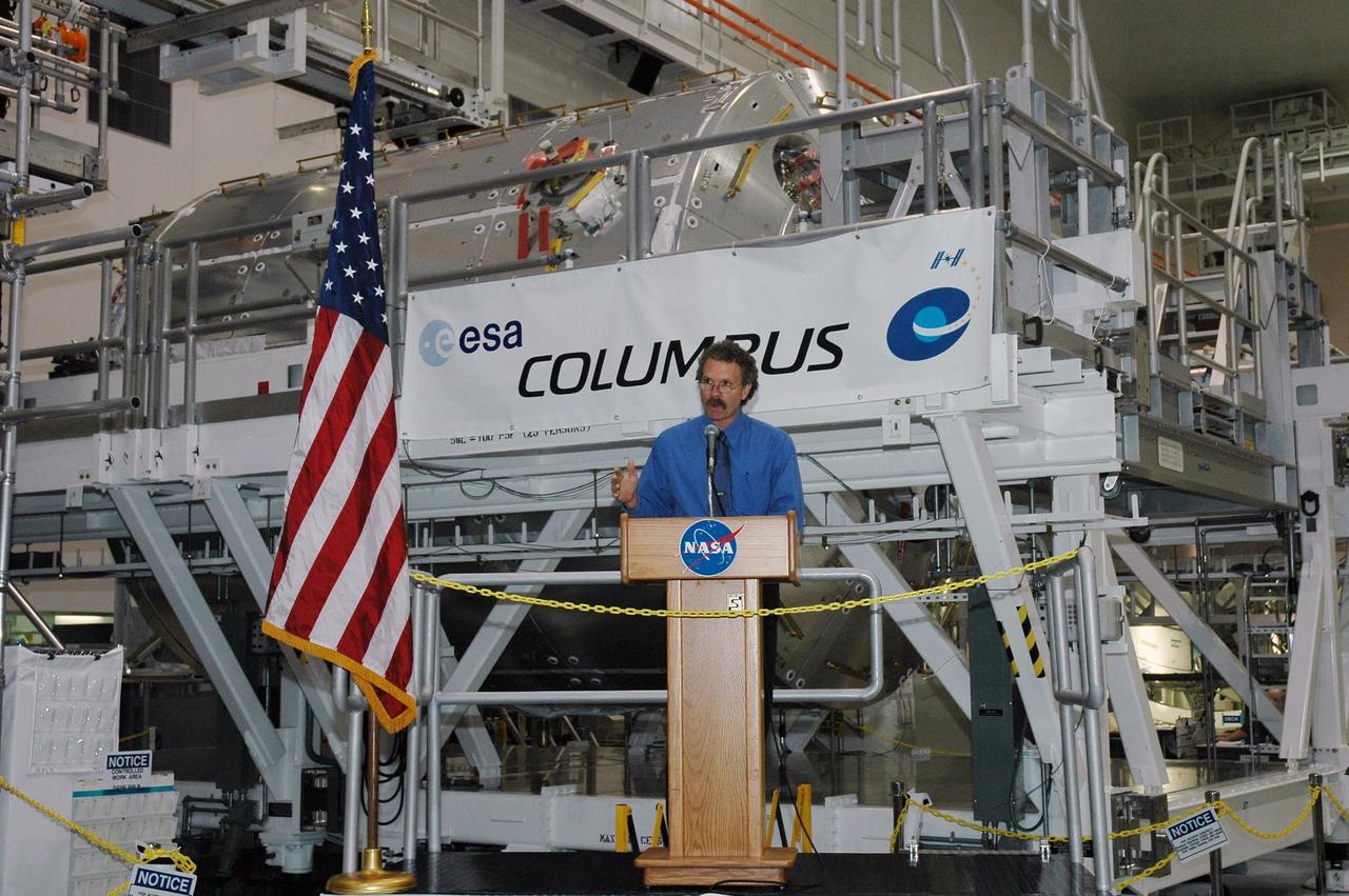 KENNEDY SPACE CENTER, FLA. - At ceremony in the Space Station Processing Facility, Russell Romanella, director of International Space Station and Payloads Processing at Kennedy Space Center, relays his team's readiness to prepare the European Space Agency's Columbus module (seen behind him) for flight. Columbus is the European Space Agency's research laboratory for the International Space Station. The module will be prepared in the SSPF for delivery to the space station on a future space shuttle mission. Columbus will expand the research facilities of the station and provide researchers with the ability to conduct numerous experiments in the life, physical and materials sciences. Photo credit: NASA/Amanda Diller