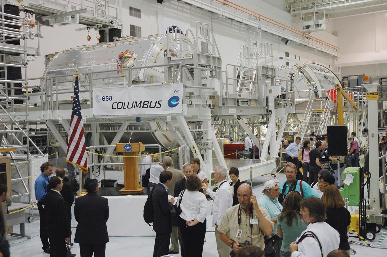 KENNEDY SPACE CENTER, FLA. - The European Space Agency's Columbus module rests on a work stand in view of media representatives and invited guests following a ceremony to welcome the module into the Space Station Processing Facility (SSPF). Columbus is the European Space Agency's research laboratory for the International Space Station. The module will be prepared in the SSPF for delivery to the space station on a future space shuttle mission. Columbus will expand the research facilities of the station and provide researchers with the ability to conduct numerous experiments in the life, physical and materials sciences. Photo credit: NASA/Amanda Diller