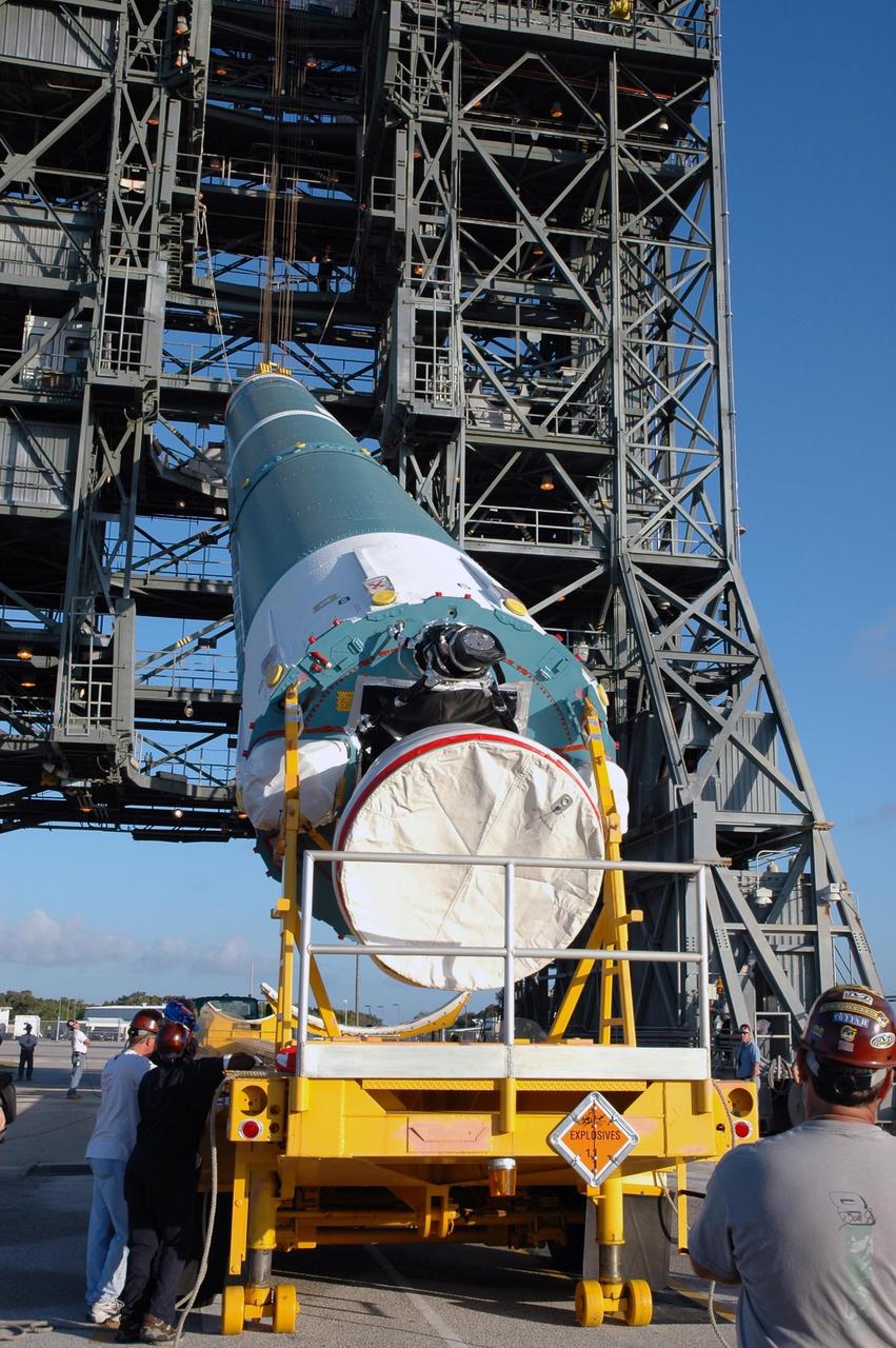 KENNEDY SPACE CENTER, FLA. - Workers supervise the lift of the first stage of the Boeing Delta II rocket, slated to launch NASA's Solar Terrestrial Relations Observatory (STEREO), into the mobile service tower at Pad 17B on Cape Canaveral Air Force Station.  Preparations are under way for a liftoff no earlier than July 22. STEREO consists of two spacecraft whose mission is the first to take measurements of the sun and solar wind in 3-D. This new view will improve our understanding of space weather and its impact on the Earth. Photo credit: NASA/Jim Grossmann