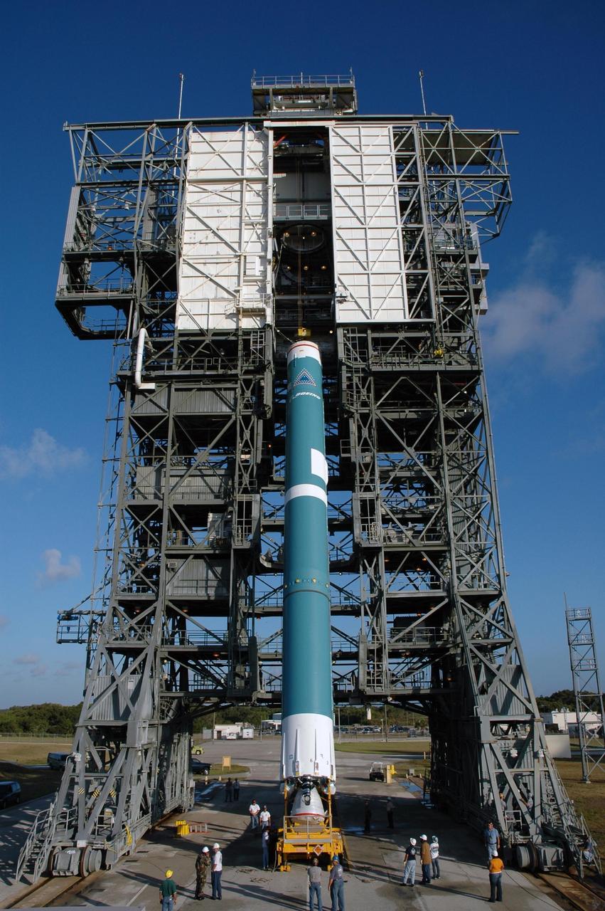KENNEDY SPACE CENTER, FLA. - The first stage of the Boeing Delta II rocket, slated to launch NASA's Solar Terrestrial Relations Observatory (STEREO), is lifted into a vertical position for installation into the mobile service tower at Pad 17B on Cape Canaveral Air Force Station. Preparations are under way for a liftoff no earlier than July 22. STEREO consists of two spacecraft whose mission is the first to take measurements of the sun and solar wind in 3-D. This new view will improve our understanding of space weather and its impact on the Earth. Photo credit: NASA/Jim Grossmann