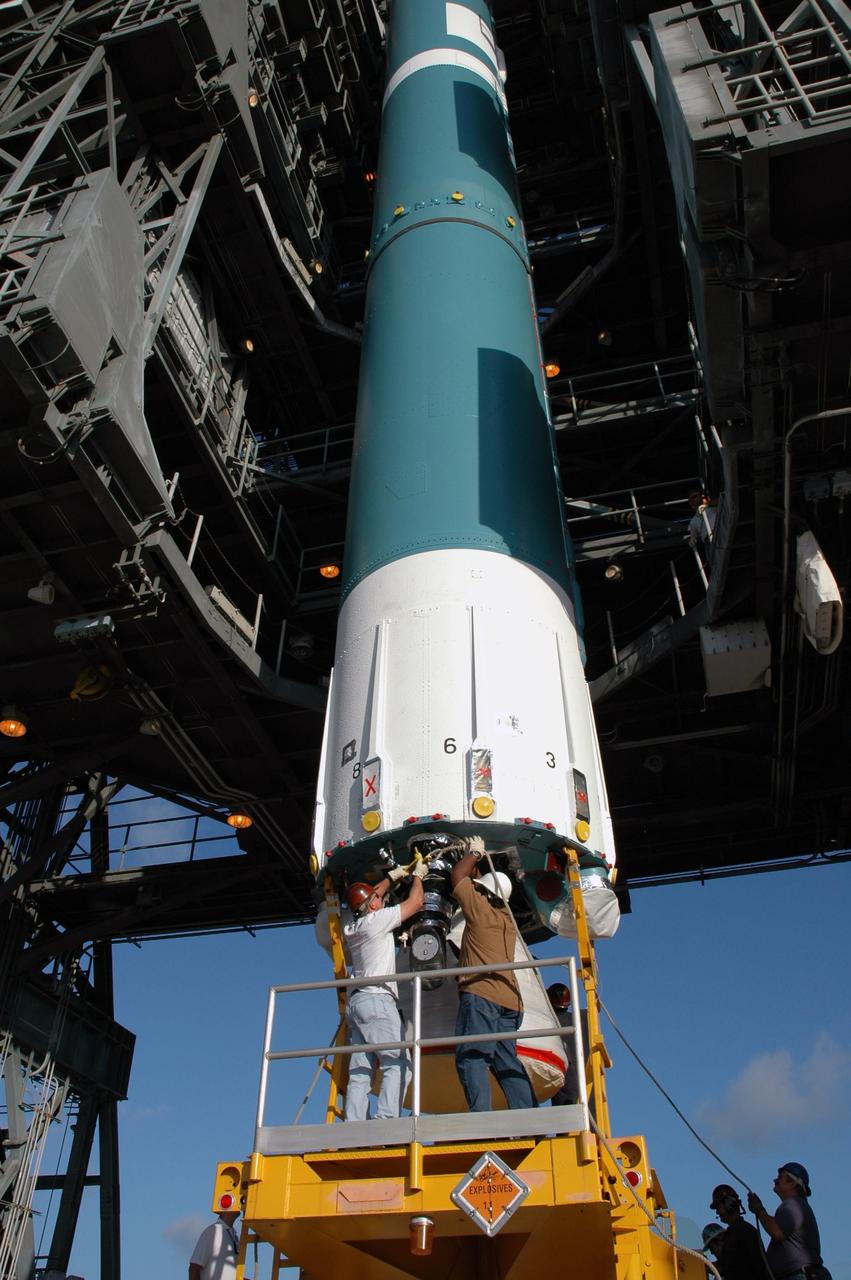 KENNEDY SPACE CENTER, FLA. - Workers prepare the first stage of the Boeing Delta II rocket, slated to launch NASA's Solar Terrestrial Relations Observatory (STEREO), for installation into the mobile service tower at Pad 17B on Cape Canaveral Air Force Station. Preparations are under way for a liftoff no earlier than July 22. STEREO consists of two spacecraft whose mission is the first to take measurements of the sun and solar wind in 3-D. This new view will improve our understanding of space weather and its impact on the Earth. Photo credit: NASA/Jim Grossmann