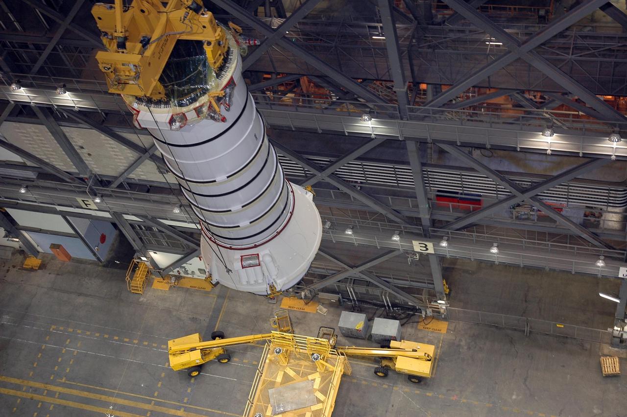 KENNEDY SPACE CENTER, FLA. - In the Vehicle Assembly Building at NASA's Kennedy Space Center, a solid rocket booster segment is lifted off its transporter below.  The segment is being lifted up into high bay 3 and will be placed on mobile launcher platform No. 2 for use on mission STS-115.   The mission will deliver a truss and other key components to the International Space Station.  Launch is currently scheduled for late August.  Photo credit: NASA/Charisse Nahser