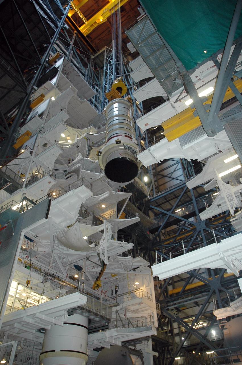 KENNEDY SPACE CENTER, FLA. - In the Vehicle Assembly Building at NASA's Kennedy Space Center, a solid rocket booster segment is lowered into high bay 3 where it will be placed on mobile launcher platform No. 2 for use on mission STS-115.  The mission will deliver a truss and other key components to the International Space Station.  Launch is currently scheduled for late August.  Photo credit: NASA/Charisse Nahser