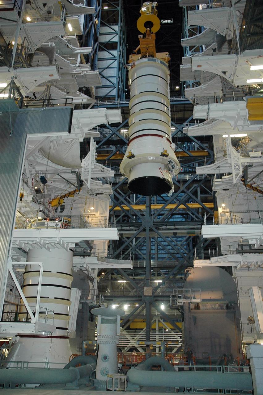 KENNEDY SPACE CENTER, FLA. - In high bay 3 of the Vehicle Assembly Building at NASA's Kennedy Space Center, a solid rocket booster segment is lowered toward mobile launcher platform No. 2 for use on mission STS-115.  The mission will deliver a truss and other key components to the International Space Station.  Launch is currently scheduled for late August.  Photo credit: NASA/Charisse Nahser