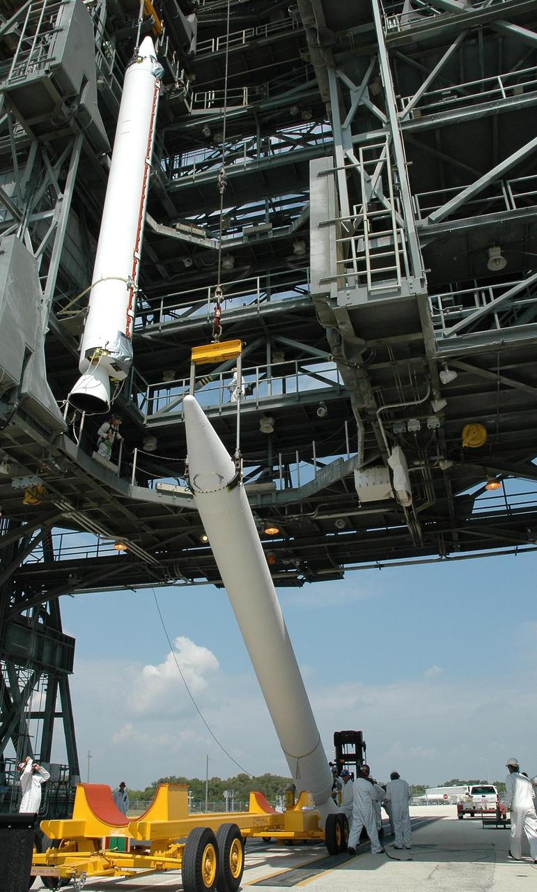 KENNEDY SPACE CENTER, FLA. - A second solid rocket booster is lifted off its transporter on Launch Pad 17-B at Cape Canaveral Air Force Station. It will be lifted into the mobile service tower above to join the other booster at left. The boosters will be mated with the Boeing Delta II rocket already in place. The Delta rocket is the launch vehicle for NASA's Solar Terrestrial Relations Observatory (STEREO). Preparations are under way for a liftoff no earlier than July 22. STEREO consists of two spacecraft whose mission is the first to take measurements of the sun and solar wind in 3-D. This new view will improve our understanding of space weather and its impact on the Earth. Photo credit: NASA/Jack Pfaller