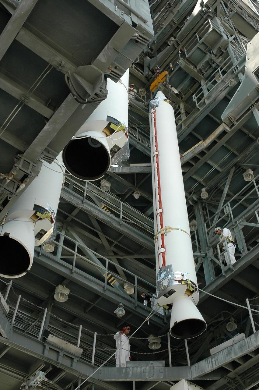 KENNEDY SPACE CENTER, FLA. - Another solid rocket booster is lifted into the mobile service tower on Launch Pad 17-B at Cape Canaveral Air Force Station. It will join the others at left for mating with the Boeing Delta II rocket already in place. The Delta rocket is the launch vehicle for NASA's Solar Terrestrial Relations Observatory (STEREO). Preparations are under way for a liftoff no earlier than July 22. STEREO consists of two spacecraft whose mission is the first to take measurements of the sun and solar wind in 3-D. This new view will improve our understanding of space weather and its impact on the Earth. Photo credit: NASA/Jack Pfaller