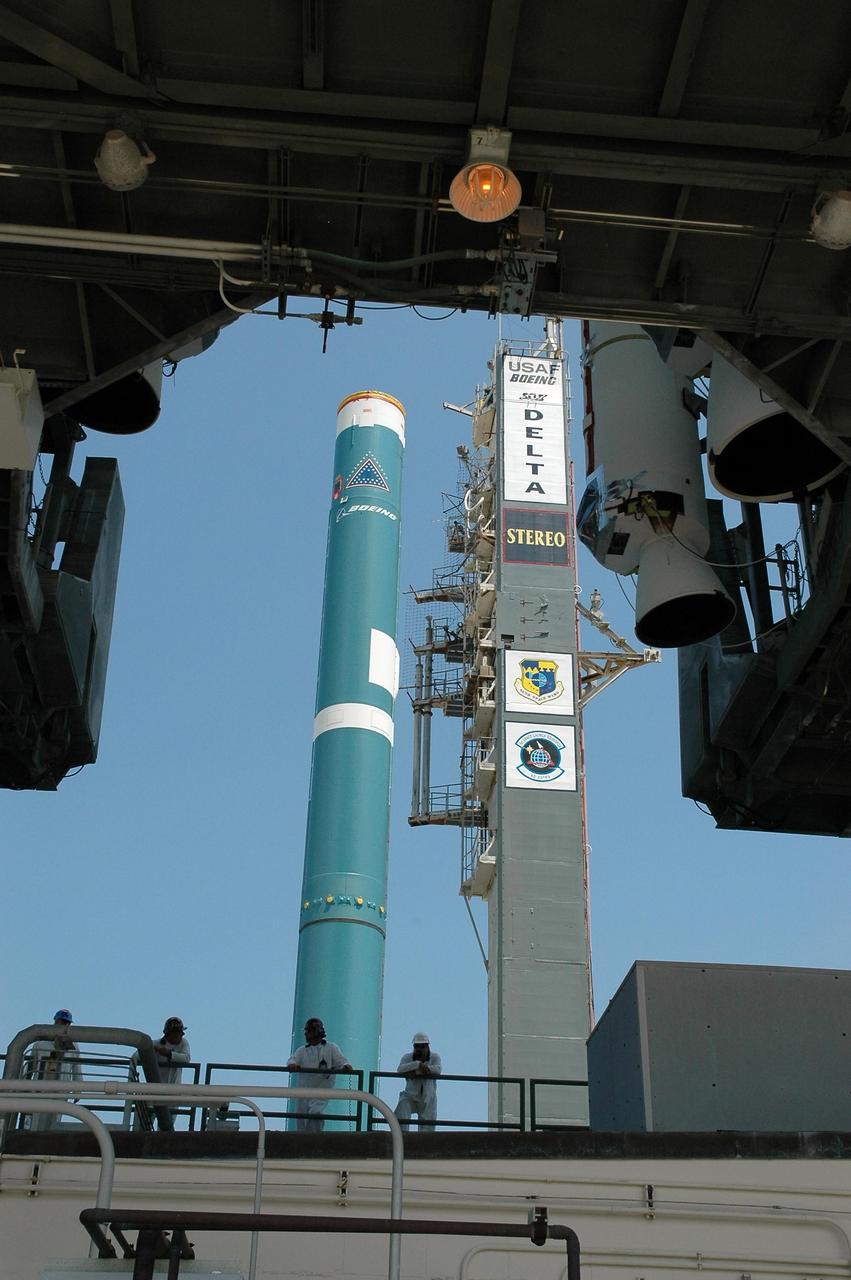 KENNEDY SPACE CENTER, FLA. -    A Boeing Delta II rocket is seen from under the mobile service tower on Launch Pad 17-B at Cape Canaveral Air Force Station.  Visible on the tower at right are the lower portions of the solid rocket boosters that will be mated to the Delta II.  The Delta rocket is the launch vehicle for NASA's Solar Terrestrial Relations Observatory (STEREO).  Preparations are under way for a liftoff no earlier than July 22. STEREO consists of two spacecraft whose mission is the first to take measurements of the sun and solar wind in 3-D. This new view will improve our understanding of space weather and its impact on the Earth. Photo credit: NASA/Jack Pfaller