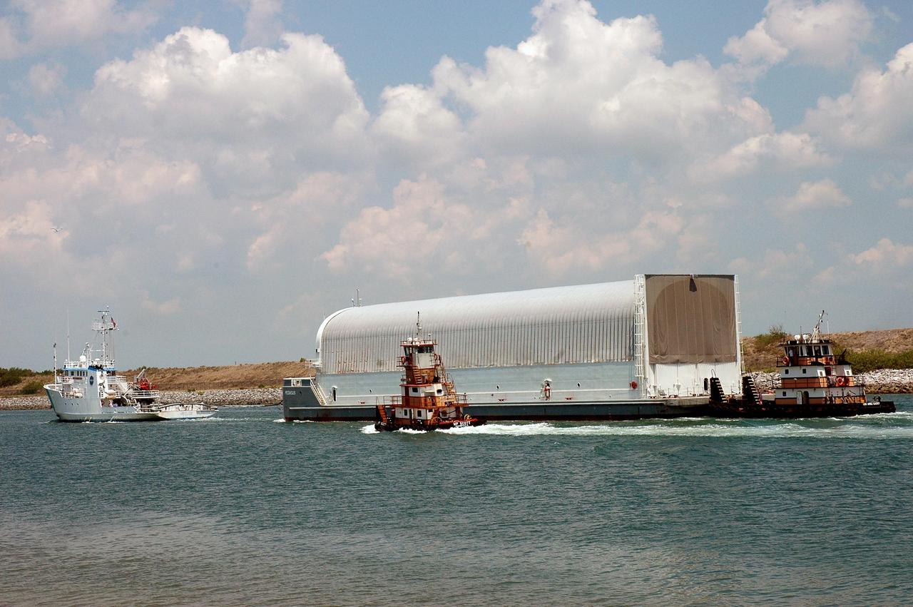 KENNEDY SPACE CENTER, FLA. -   The Liberty Star (left) tows the Pegasus barge through Port Canaveral, the last leg of its journey from the Michoud Assembly Facility in New Orleans to Kennedy Space Center. The barge carries the redesigned external fuel tank that will launch Space Shuttle Atlantis on the next shuttle mission, STS-115. A tugboat will continue the journey upriver to the Turn Basin where, after off-loading, the tank will be moved into the Vehicle Assembly Building and lifted into a checkout cell for further work. The tank, designated ET-118, will fly with many major safety changes, including the removal of the protuberance air load ramps.  Photo credit: NASA/Jack Pfaller