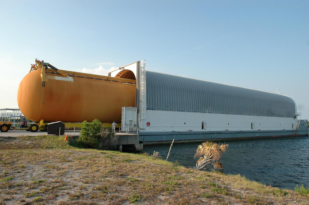 KENNEDY SPACE CENTER, FLA. - The redesigned external fuel tank, designated ET-118, that will launch Space Shuttle Atlantis on mission STS-115 is offloaded from the Pegasus barge that carried it from the Michoud Assembly Facility in New Orleans. The tank will be moved into the Vehicle Assembly Building and lifted into a checkout cell for further work. It will fly with many major safety changes, including the removal of the protuberance air load ramps. Photo credit: NASA/Kim Shiflett