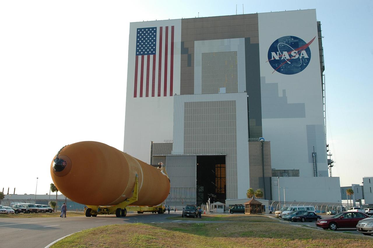 KENNEDY SPACE CENTER, FLA. - The redesigned external fuel tank, designated ET-118, rolls toward the open door of the Vehicle Assembly Building. Inside, it will be lifted into a checkout cell for further work . The tank arrived at KSC aboard the Pegasus barge after a journey from the Michoud Assembly Facility in New Orleans. ET-118, which will fly with many major safety changes, including the removal of the protuberance air load ramps, will launch Space Shuttle Atlantis on the next space shuttle mission, STS-115. Photo credit: NASA/Kim Shiflett