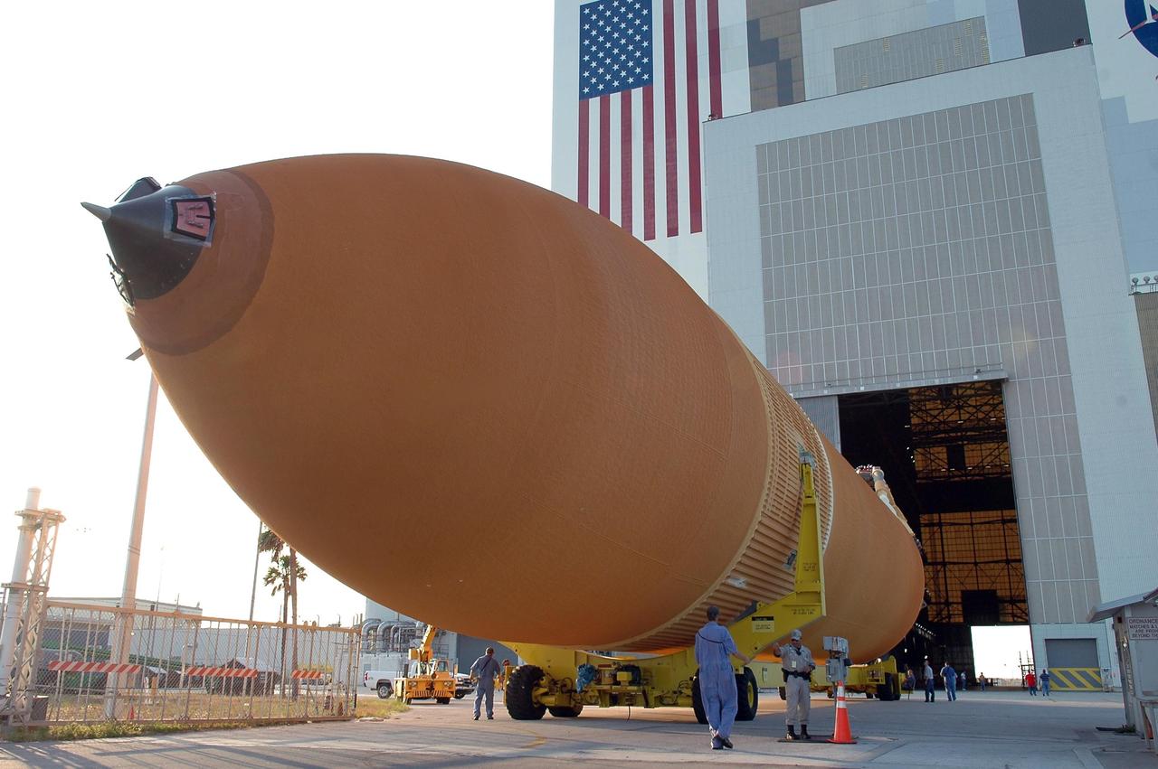 KENNEDY SPACE CENTER, FLA. - The redesigned external fuel tank, designated ET-118, rolls into the open door of the Vehicle Assembly Building. Inside, it will be lifted into a checkout cell for further work . The tank arrived at KSC aboard the Pegasus barge after a journey from the Michoud Assembly Facility in New Orleans. ET-118, which will fly with many major safety changes, including the removal of the protuberance air load ramps, will launch Space Shuttle Atlantis on the next space shuttle mission, STS-115. Photo credit: NASA/Kim Shiflett